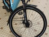 a blue bicycle parked on a tiled floor in a room