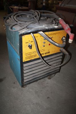 an image of a welding machine sitting in a garage