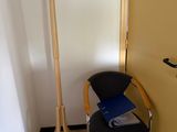 a chair and a coat rack in the corner of a room