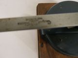 a knife that is on top of a piece of wood