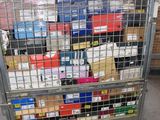 a metal cart with many boxes on it in a warehouse