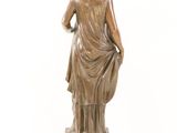 bronze statue of a woman with a draped dress on a marble base