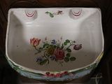 a white porcelain sink with a floral design on it