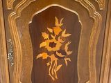 a wooden cabinet with a floral design on it