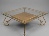 a brass and glass coffee table with a square glass top