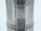 a silver metal container with a metal strap on it