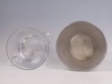 two empty cups sitting next to each other on a table