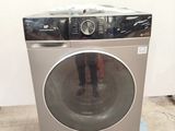 a washing machine sitting on a pallet in a room