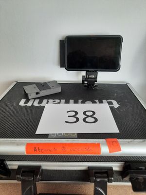 une valise sur laquelle est posé un téléphone, avec une étiquette de prix accrochée dessus
