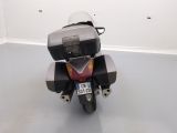 a motorcycle parked in a room with a white wall