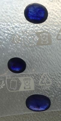 a close up picture of a blue glass object on a table