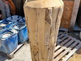 a large vase made out of wood sitting on a pallet