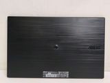 the back of a laptop with a black cover sitting on a white surface