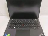 laptop with a black keyboard and a blue button on the keyboard