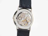 a close up of a wrist watch with a black leather strap