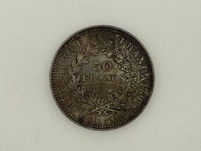 a close up of a coin on a white surface