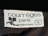 a close up of a label on the back of a black jacket