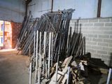 a large pile of wood in a room with a brick wall