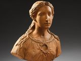 a carved bust of a woman on a pedestal