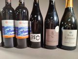 several bottles of wine are lined up on a table
