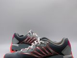 a pair of grey and pink running shoes on a white background