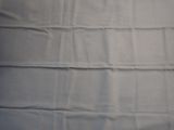 a close up of a sheet of white fabric on a bed