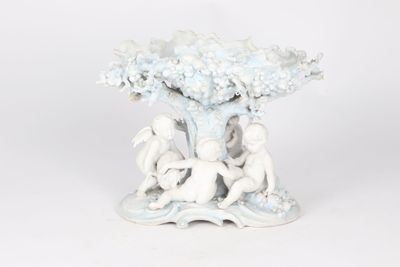 porcelain figurine of two children playing under a tree
