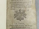 an old book that is open on a table