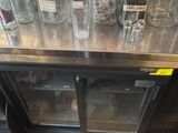 a metal counter with a bunch of glass jars on top of it