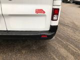 a white van with a red sticker on the back of it