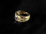 a close up of a gold ring on a black surface