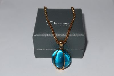 the necklace is in a box with a chain around it