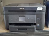 a printer sitting on top of a desk next to a printer