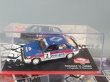 three toy cars are in a display case on a table