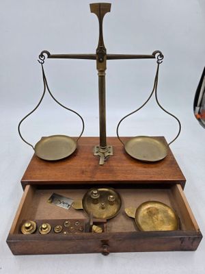 une boîte en bois sur laquelle est posée une balance