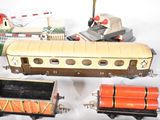 several toy trains are lined up on a white surface