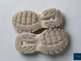 two pairs of shoes that are on a white surface