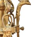 a large gold vase with a dragon handle on it