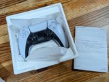 a white box with a black game controller inside of it