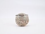 a close up of a small silver object on a white surface