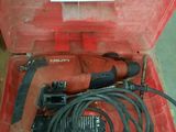 a red box with a hammer and a cord in it