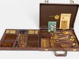 a brown case with silverware in it on a white surface