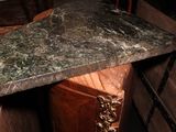 a marble table top sitting on top of a wooden table