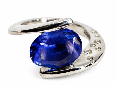 an image of a ring with a blue sapphire stone on it