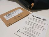 a tag on the back of a jacket that is on a table