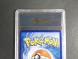 the pokemon card is in a plastic holder on a table