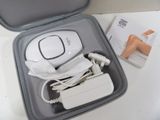 a white device in a case on a white table