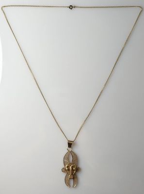 a gold necklace with a small elephant on it ' s neck
