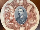 a plate with a picture of a man on it sitting on a table