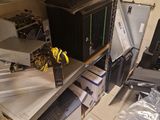 a lot of computer equipment on the shelves in the room